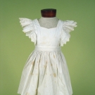 CHILD'S RUFFLED WHITE PINAFORE, 1890s